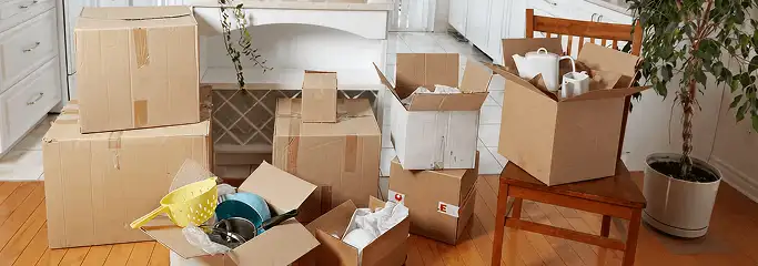 Packed moving boxes and household items in a kitchen before move-out or move-in cleaning, San Antonio, TX.